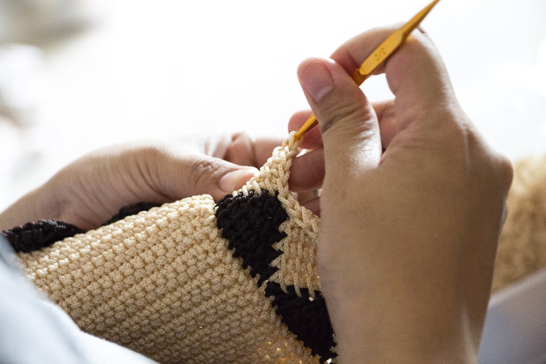 A person crocheting.